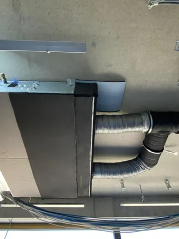 Gedämmtes Lüftungsgerät an der Betondecke mit zwei Anschlussrohren